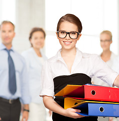 Image showing young attractive businesswoman with folders