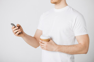 Image showing man with smartphone and coffee