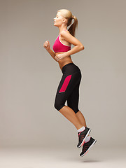 Image showing sporty woman running or jumping