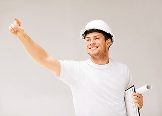 Image showing male architect looking at blueprint