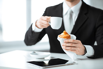 Image showing man with tablet pc and cup of coffee