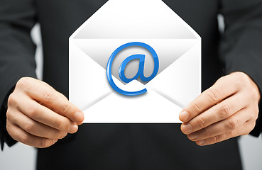 Image showing man in suit holding envelope with email sign