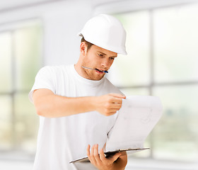 Image showing male architect looking at blueprint