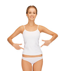 Image showing woman in blank shirt pointing at her belly