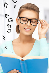 Image showing woman in glasses reading book