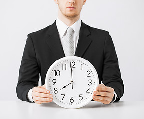 Image showing man with wall clock