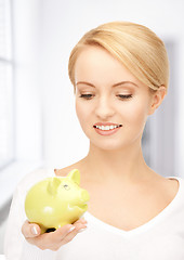 Image showing lovely woman with piggy bank