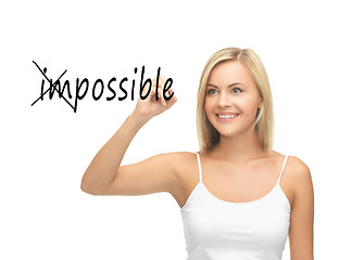 Image showing woman writing the word (im)possible in the air