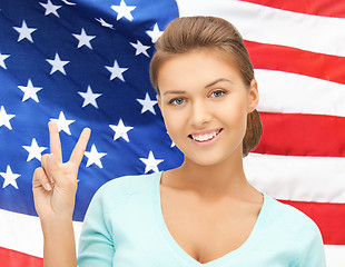 Image showing young woman showing victory or peace sign