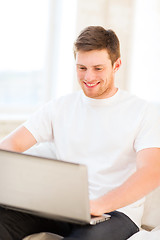 Image showing man working with laptop at home