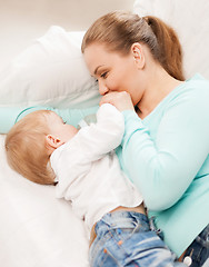 Image showing mother and adorable baby with feeding-bottle