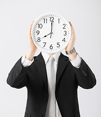 Image showing man with wall clock