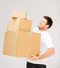 Image showing young man carrying carton boxes