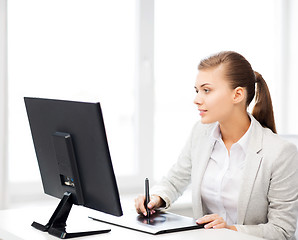 Image showing businesswoman with drawing tablet in office