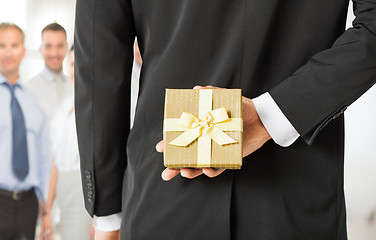 Image showing man hands holding gift box in office