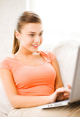 Image showing happy woman using laptop at home