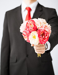 Image showing man giving bouquet of flowers