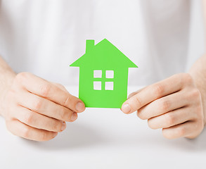 Image showing hands holding green house