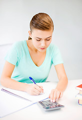 Image showing student girl with notebook and calculator