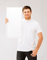 Image showing young man holding white blank board