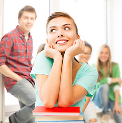 Image showing happy smiling student girl with books at school