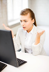 Image showing stressed student with computer in office