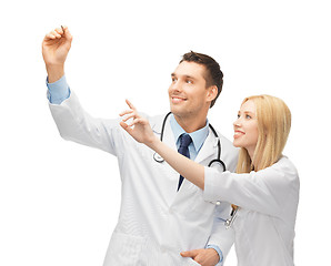 Image showing young doctors working with something imaginary