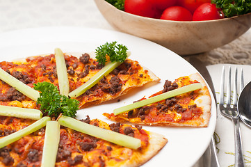 Image showing Turkish beef pizza with cucumber on top