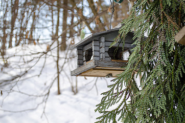 Image showing bird feeder nailed small logs with holes in winter 