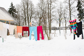 Image showing colorful wash clothes loundry dry rope winter snow 