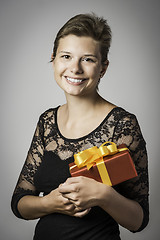 Image showing Happy girl with evening dress and present