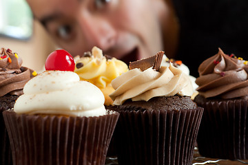 Image showing Man Looks At Cupcakes