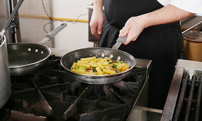 Image showing Chef cooking rigatoni with vegetables in a pan