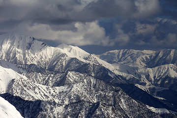 Image showing Winter mountains in clouds. View from ski slopes