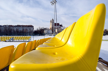Image showing yellow chairs row volleyball court in winter 