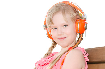 Image showing Girl with pigtails listening language lessons in headphones isol