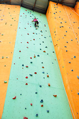 Image showing child climbing up the wall