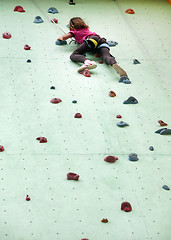 Image showing child climbing up the wall