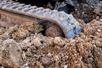 Image showing Digger tracks running through soil and stones