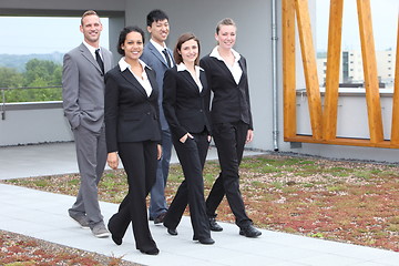 Image showing Stylish young business team walking together