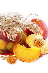 Image showing Jars of jam and fresh peaches.