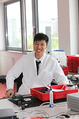 Image showing Smiling Asian man working in a laboratory