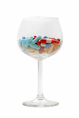 Image showing Glass with pills