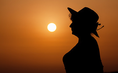 Image showing Silhouette woman portrait against orange sunset