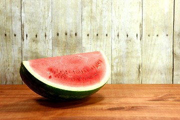 Image showing Fruit Sliced Sitting on a Wooden Surface