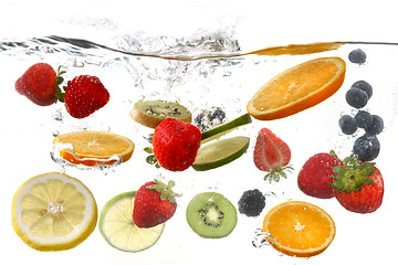 Image showing Fruits Falling Into Splashing Clear Water