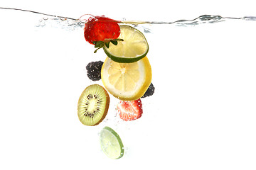 Image showing Fruits Falling Into Splashing Clear Water