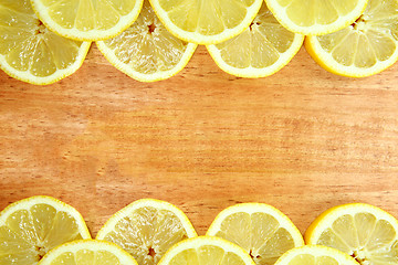 Image showing Fruit Sliced Sitting on a Wooden Surface