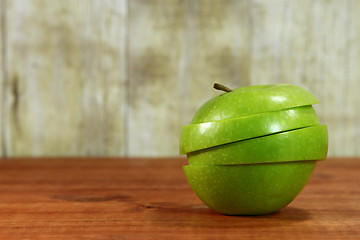 Image showing Fruit Sliced Sitting on a Wooden Surface