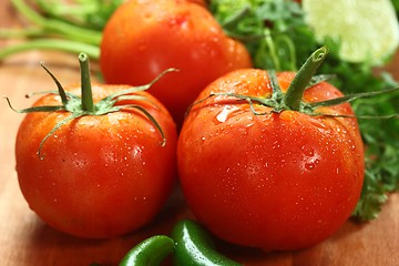 Image showing Tomatoes on a Rustic Wood Plank